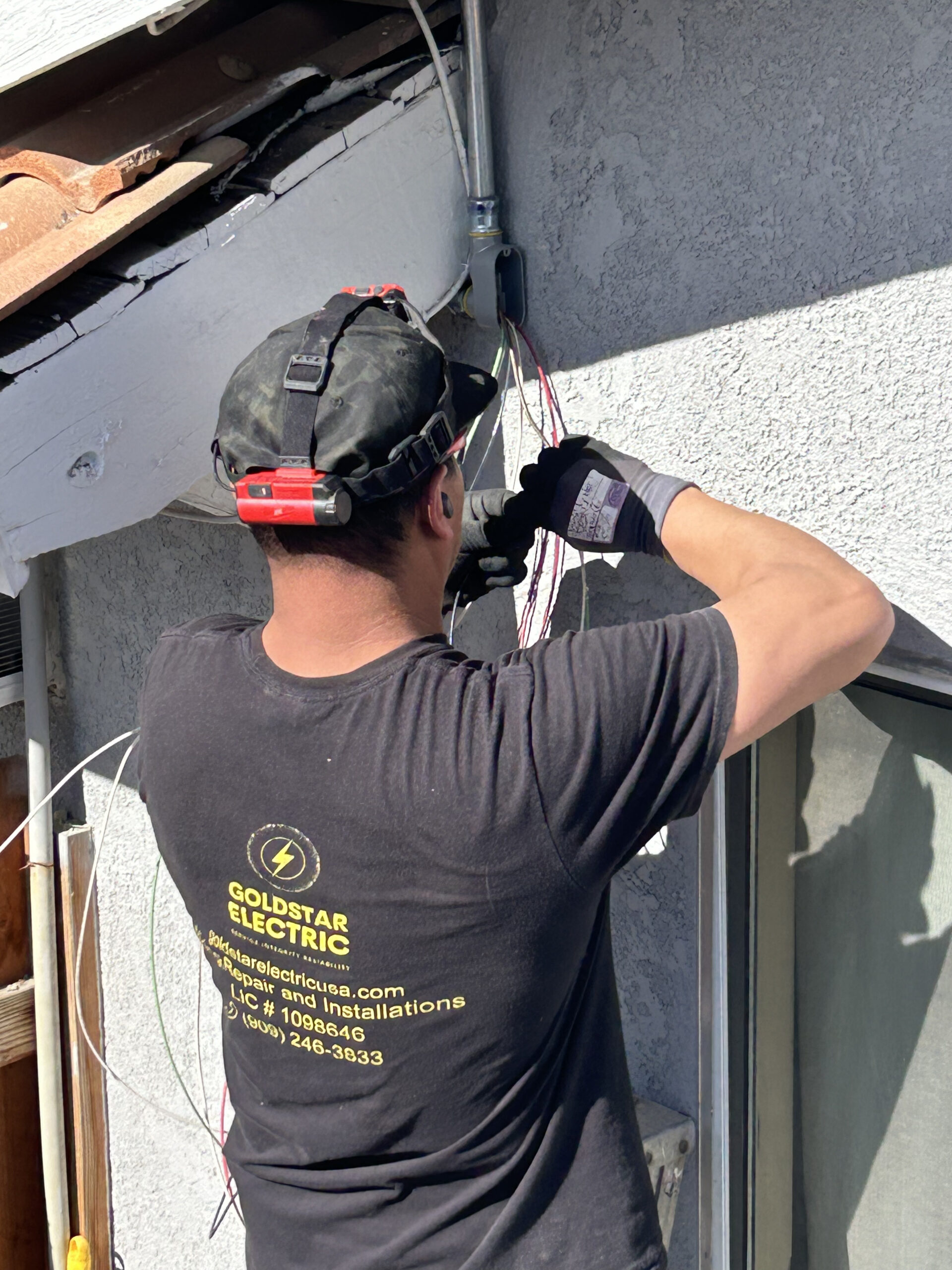 Professional residential electrician performing a safe electrical installation for Gold Star Electric.