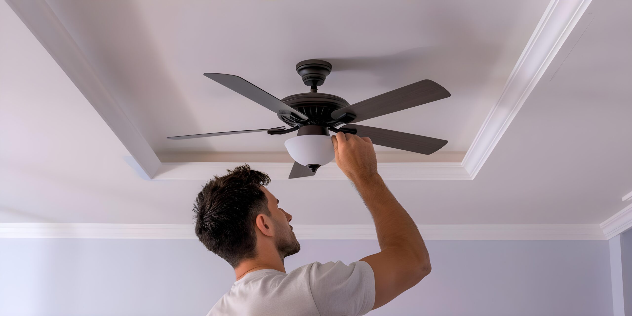 Certified residential electrician inspecting the installation of a ceiling fan.