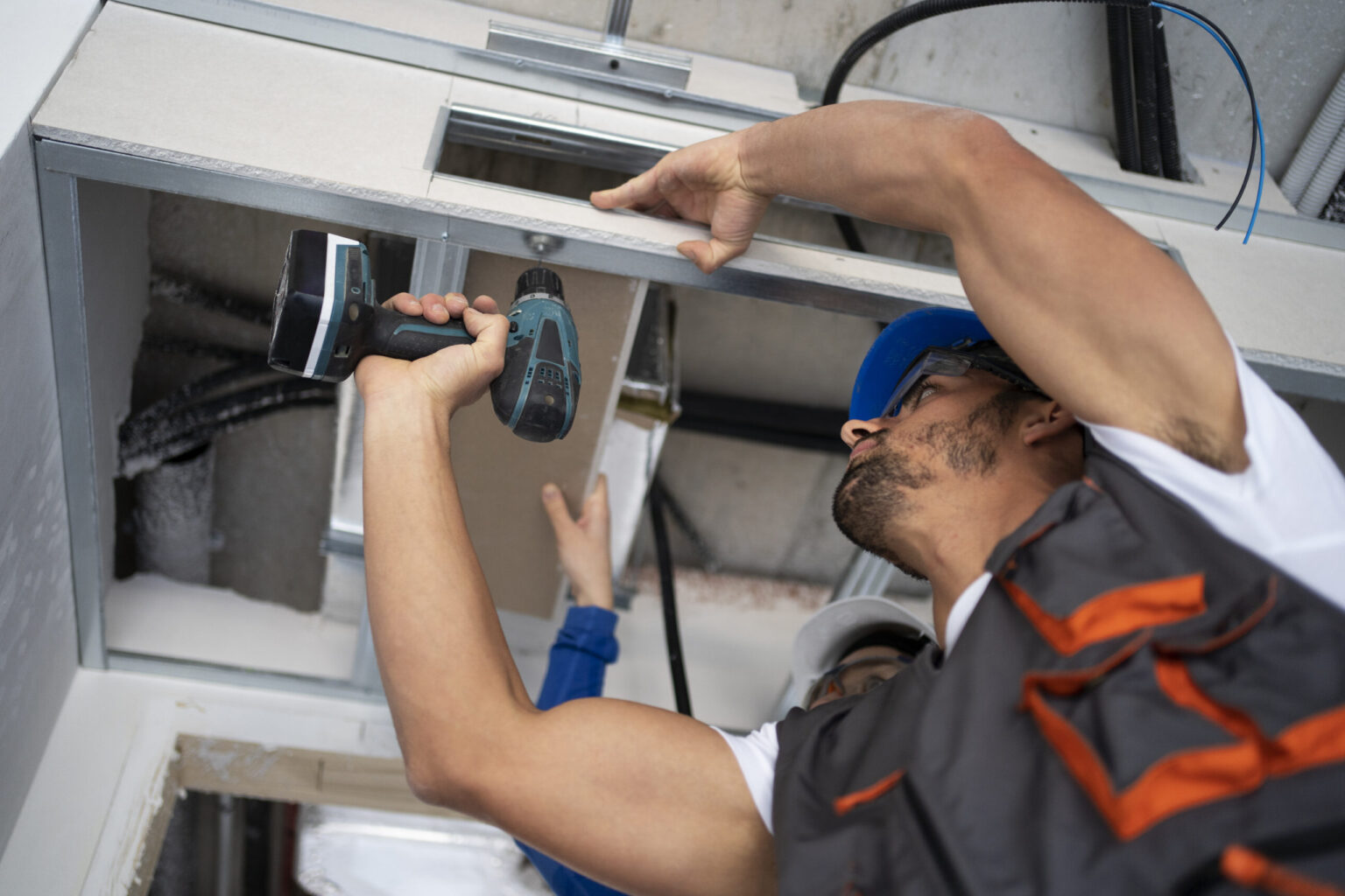 Professional residential electrician upgrading electrical outlets in a house.